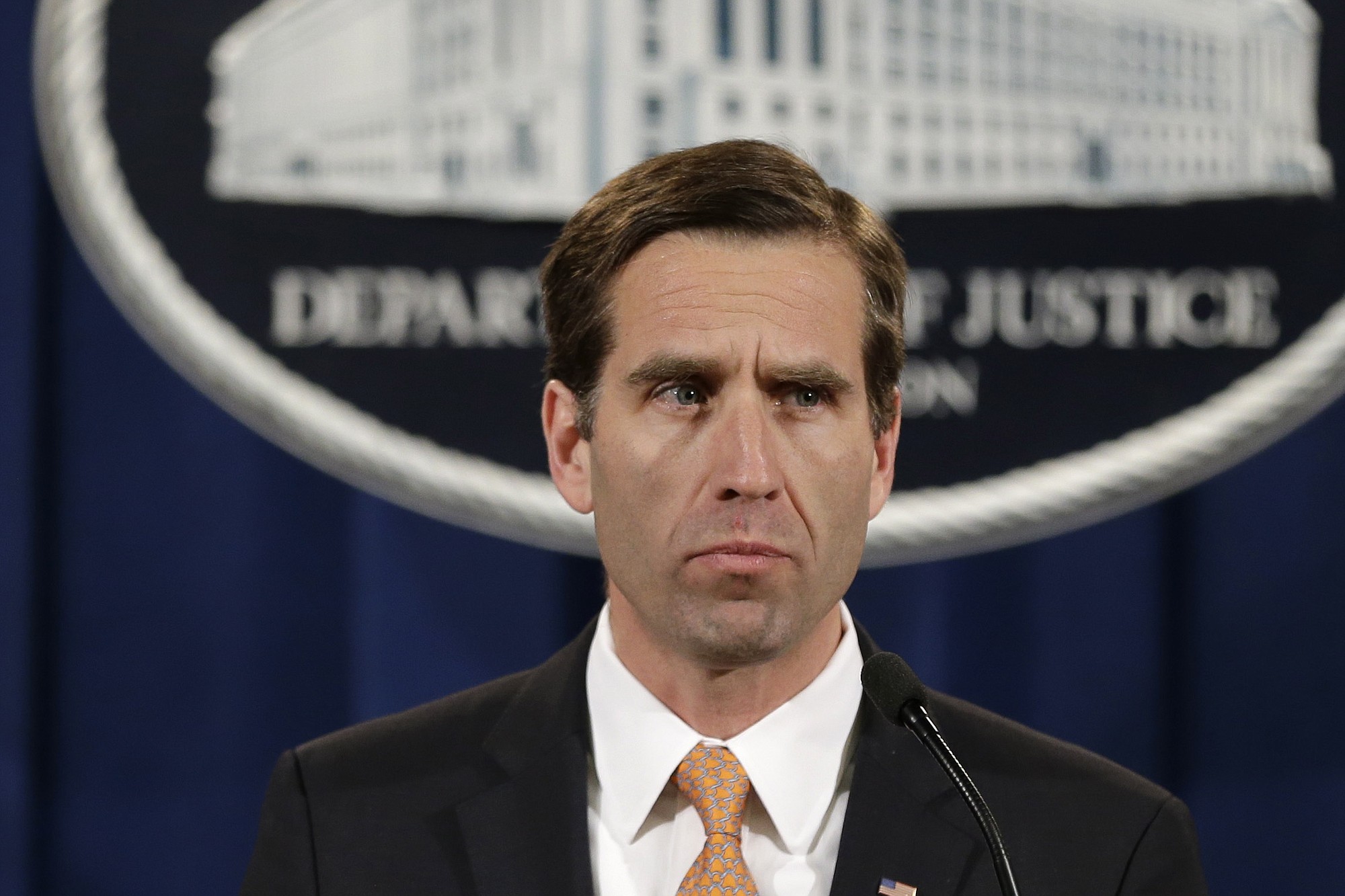 Delaware Attorney General Beau Biden pauses while speaking at a February 2013 news conference at the Justice Department in Washington.