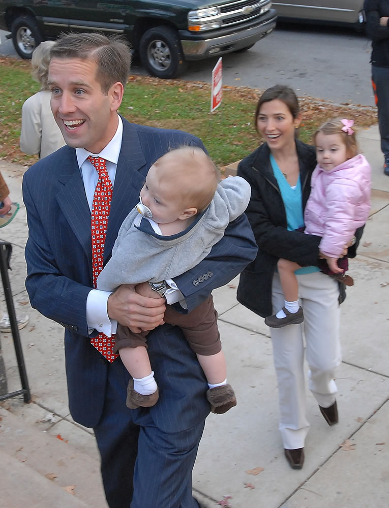 Delaware Attorney General candidate Beau Biden, holds his son, Hunter, as he walks with his wife, Hallie, holding their daughter, Natalie, as they enter a polling place to cast their votes in November 2006 in Wilmington, Del.