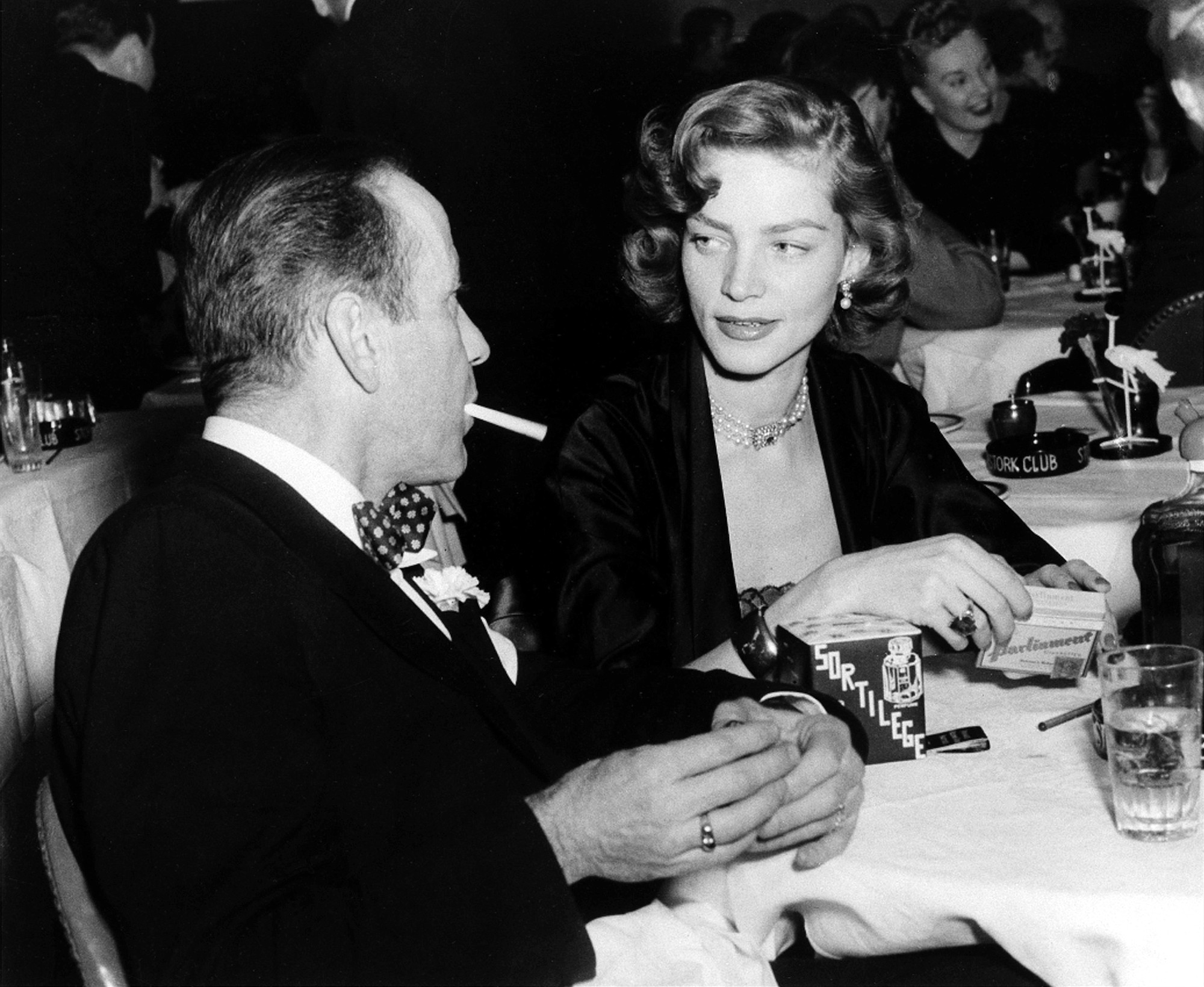 Actor Humphrey Bogart, left, and his wife, actress Lauren Bacall, appear at the Stork Club in New York in February 1950. Bacall, the sultry-voiced actress and Humphrey Bogart's partner off and on the screen, died Tuesday in New York.