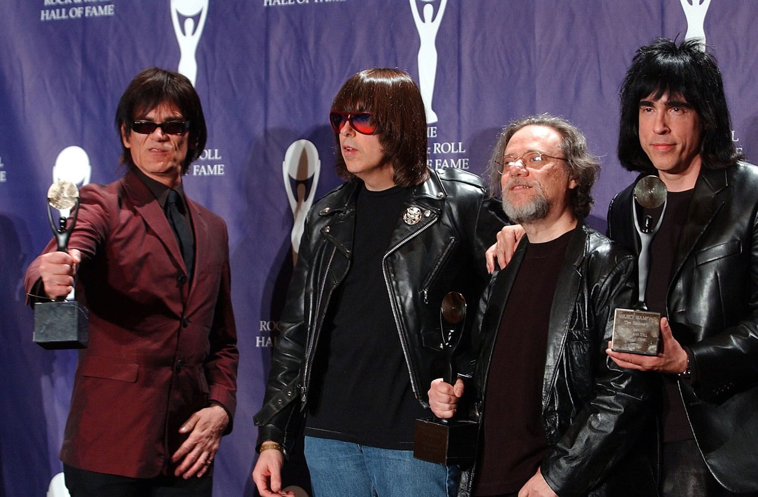 Members of the Ramones, from left to right, Dee Dee, Johnny, Tommy and Marky Ramone hold their awards March 18, 2002, after being inducted at the Rock and Roll Hall of Fame induction ceremony at New York's Waldorf Astoria. A business associate says Tommy, the last surviving member of the original group, has died.