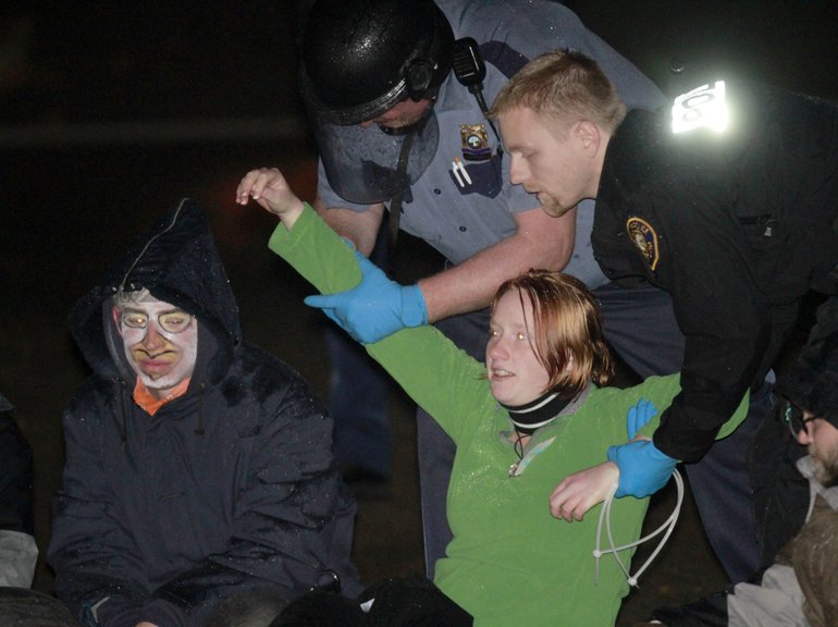 Police arrest protesters at Jamison Park in Portland early Sunday.