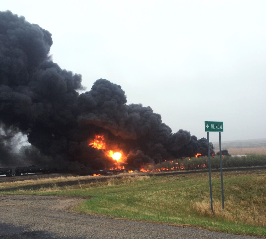 This photo provided by Curt Bemson shows smoke and fire coming from an oil train that derailed Wednesday, May 6, 2015 in Heimdal, North Dakota. Officials say ten tanker cars on the BNSF caught fire prompting the evacuation of Heimdal where about three dozen people live.