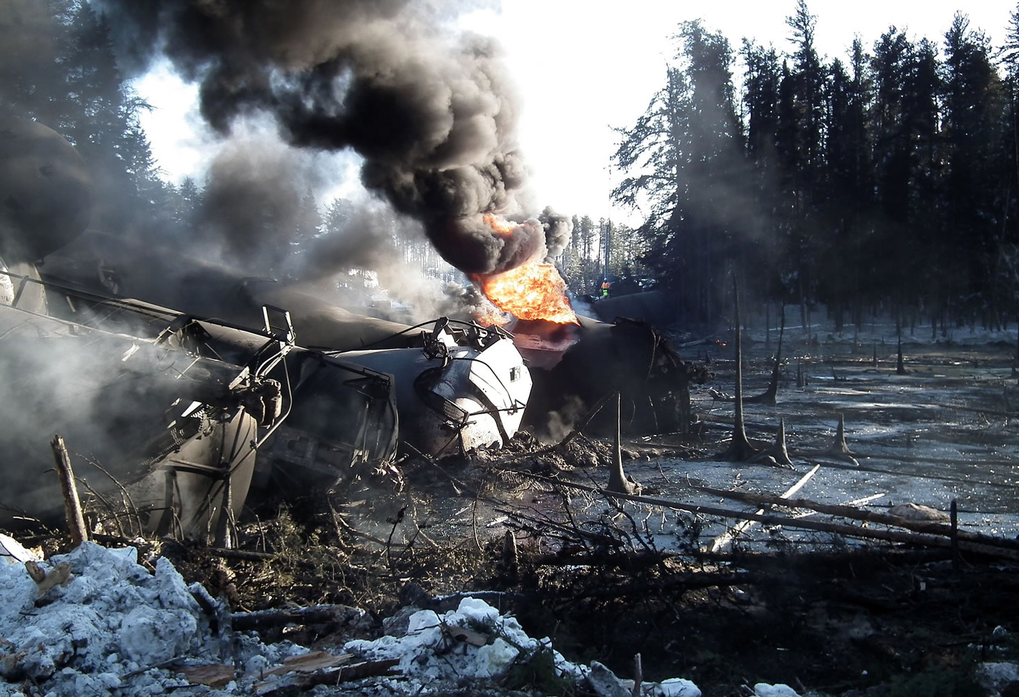 A ruptured tank car burns after a crude oil train derailment Feb.