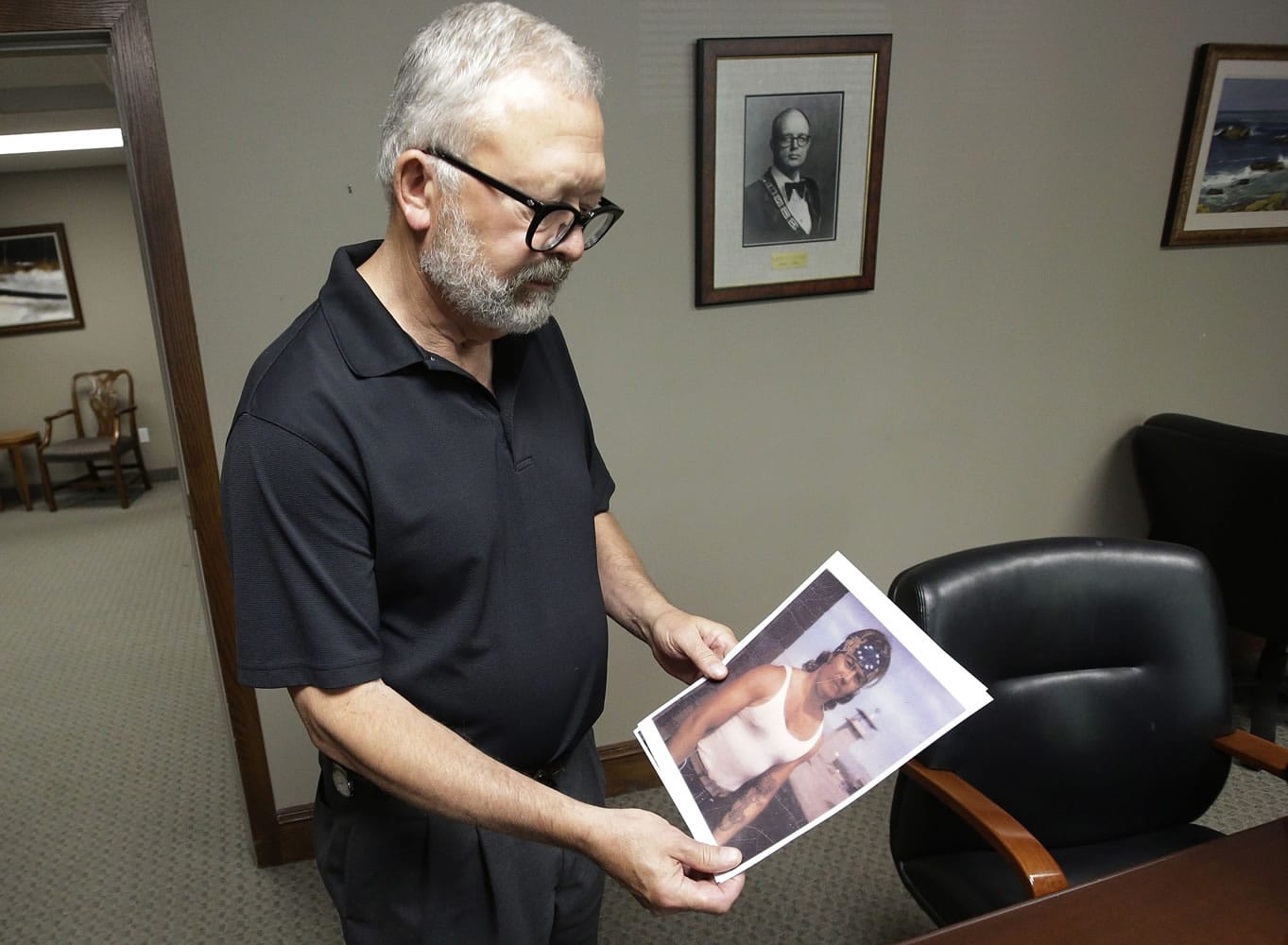 Salt Lake City attorney Jesse Trentadue holds a photograph of his brother taken in the early 1980s showing his dragon tattoo on his left forearm.