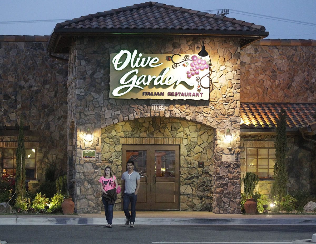 Patrons leave an Olive Garden Restaurant, a Darden restaurant brand, in Short Pump, Va. Olive Garden says its customers are opening up their wallets a little wider, a sign they may be willing to splurge as the economy improves.