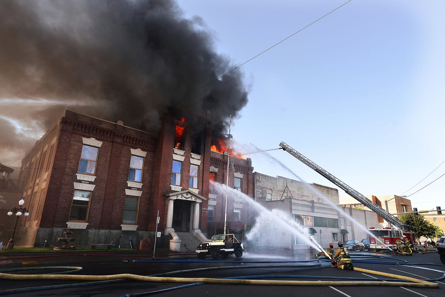 The old City Hall building burns as firefighters from all over Umatilla County battle the blaze in Pendleton, Ore., Tuesday, July 21, 2015. An explosion and fire destroyed part of the city's former government building. (E.J.