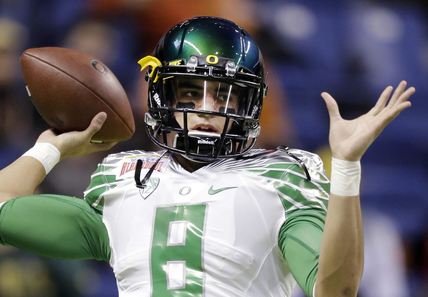 Oregon's Marcus Mariota warms up for the Valero Alamo Bowl NCAA college football game against Texas in San Antonio on Dec. 30, 2013. All eyes will be on Mariota when the Ducks take the field this season.