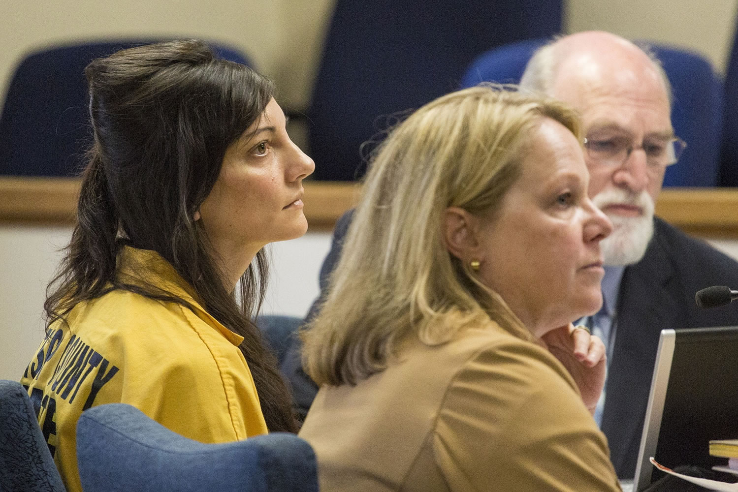 Jessica Smith sits next to defense attorneys William Falls, back, and Lynne Morgan, foreground, at the Clatsop County Courthouse for a status hearing Tuesday in Astoria, Ore.