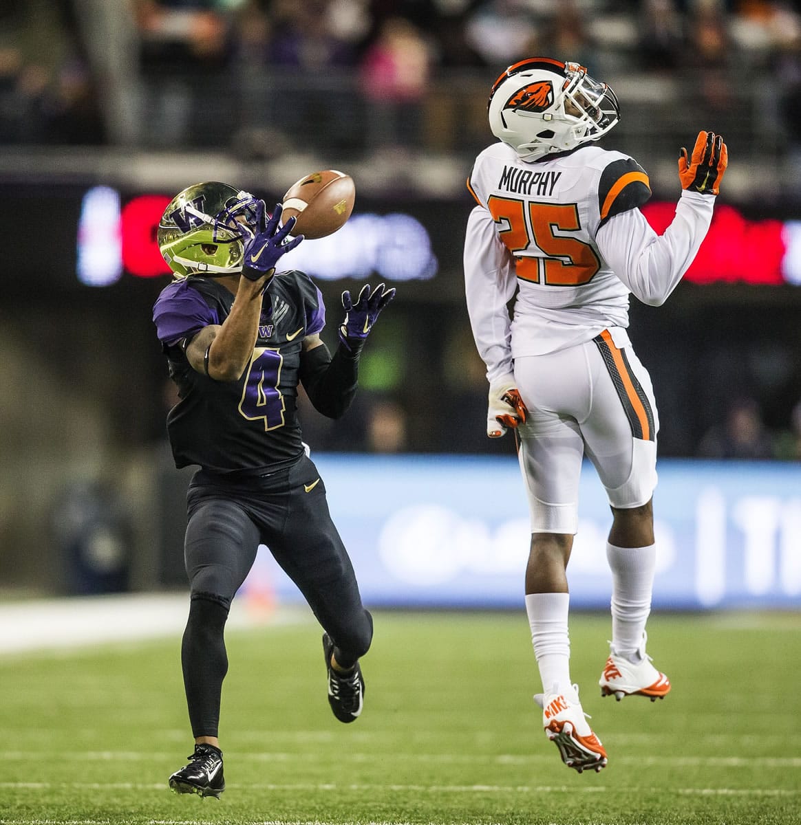 Washington's Jaydon Mickens makes a reception on a 54-yard touchdown during the first quarter as Oregon State safety Ryan Murphy defends during the first quarter Saturday, Nov. 22, 2104, in Seattle.