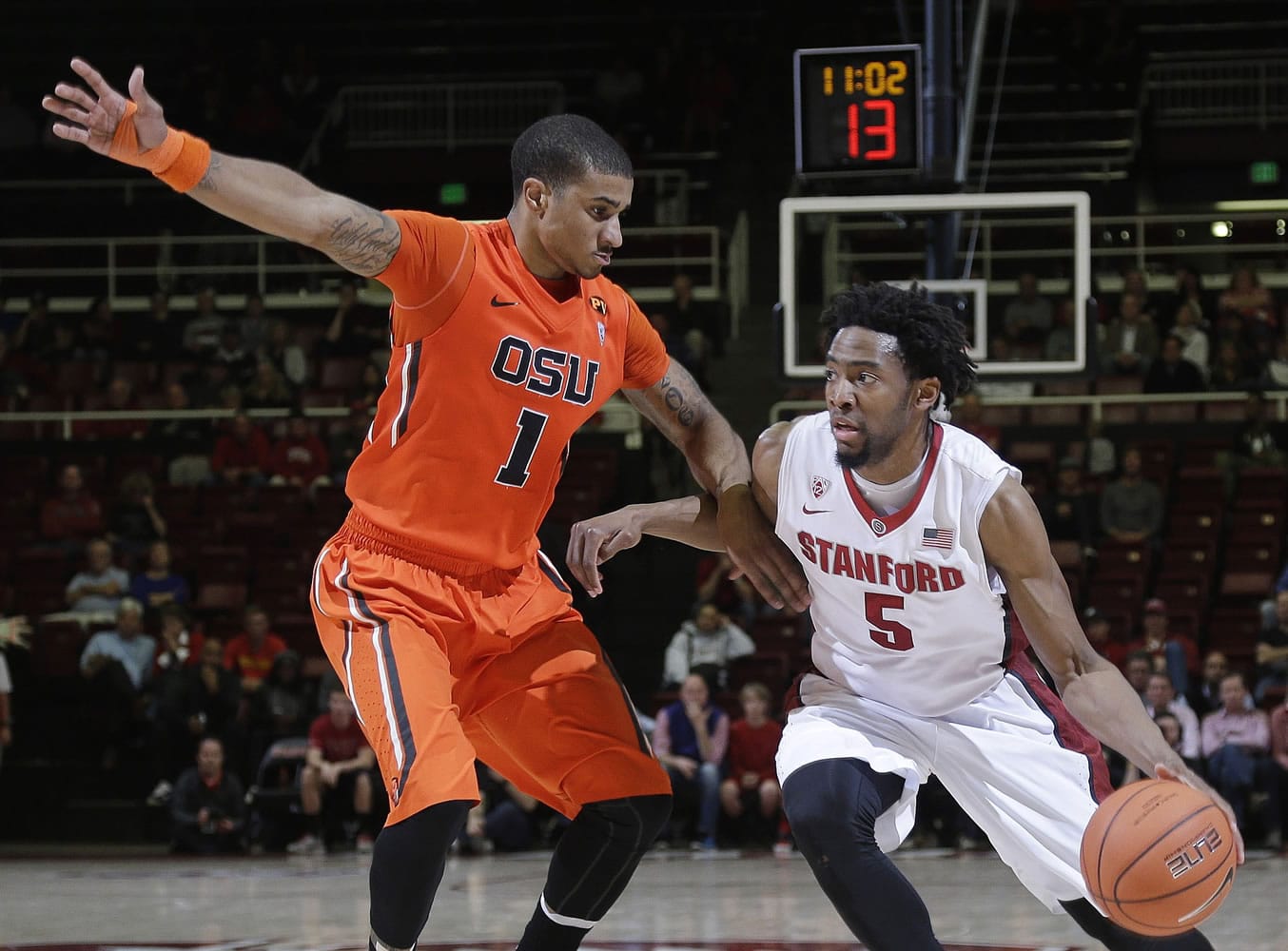 Stanford guard Chasson Randle, right, dribbles around Oregon State guard Gary Payton II during the second half Thursday, Feb. 26, 2015, in Stanford, Calif. Stanford won 75-48.
