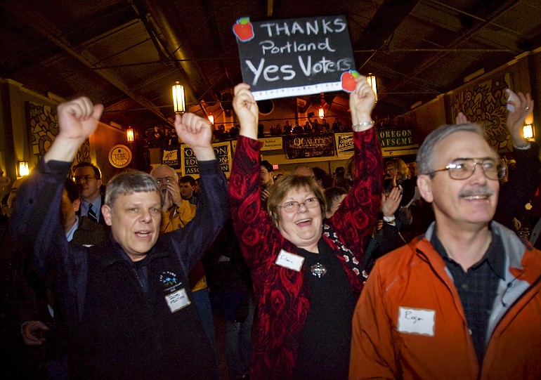 Supporters of Measures 66 and 67 celebrate early returns in Portland on Tuesday night.