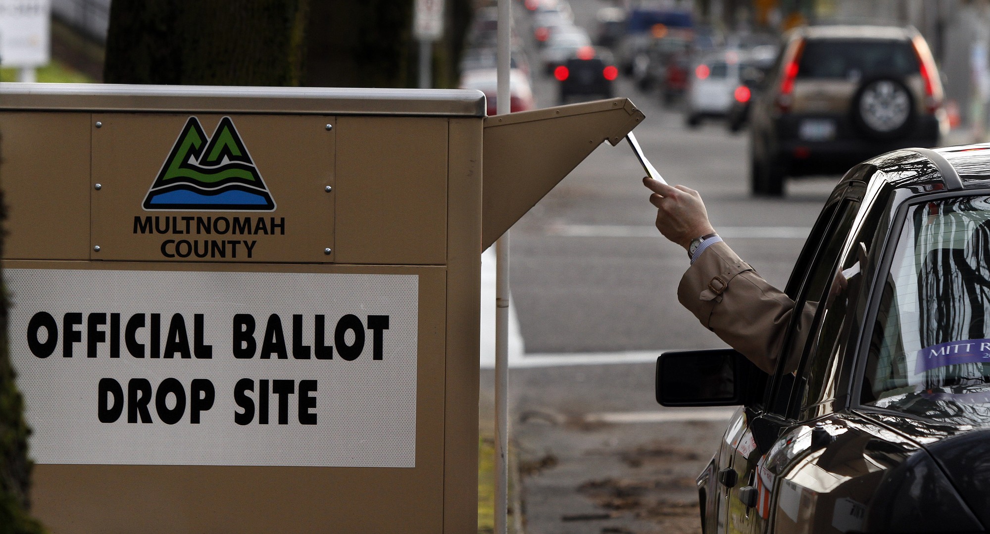 Don Ryan/Associated Press files
A motorist drops off a ballot in Portland. Oregon voters will decide this fall whether to adopt the top two election system used in Washington and California.