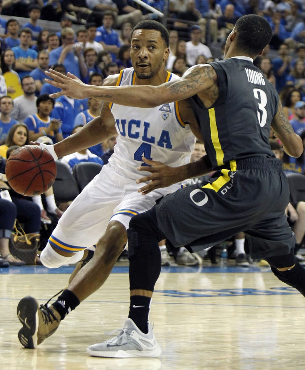 UCLA guard Norman Powell, left, drives against Oregon guard Joseph Young during the second half in Los Angeles, Saturday, Feb. 14, 2015. UCLA won 72-63.
