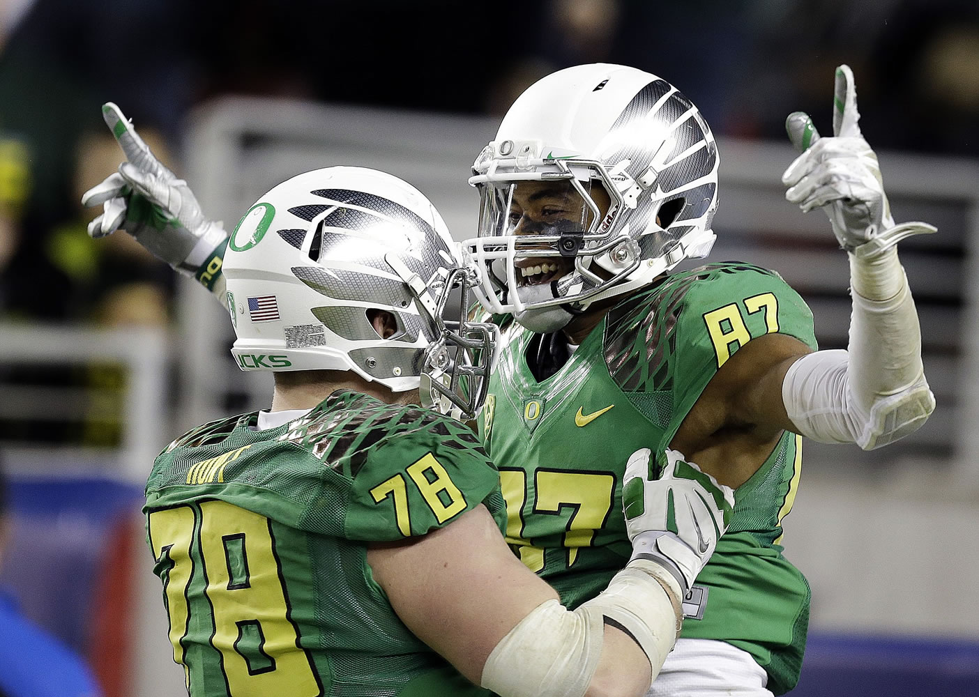 Oregon's Cameron Hunt, left, celebrates a touchdown made by Darren Carrington (87) during the second half of the Pac-12 Championship against Arizona on Friday, Dec. 5, 2014, in Santa Clara, Calif. Oregon won the game, 51-13.