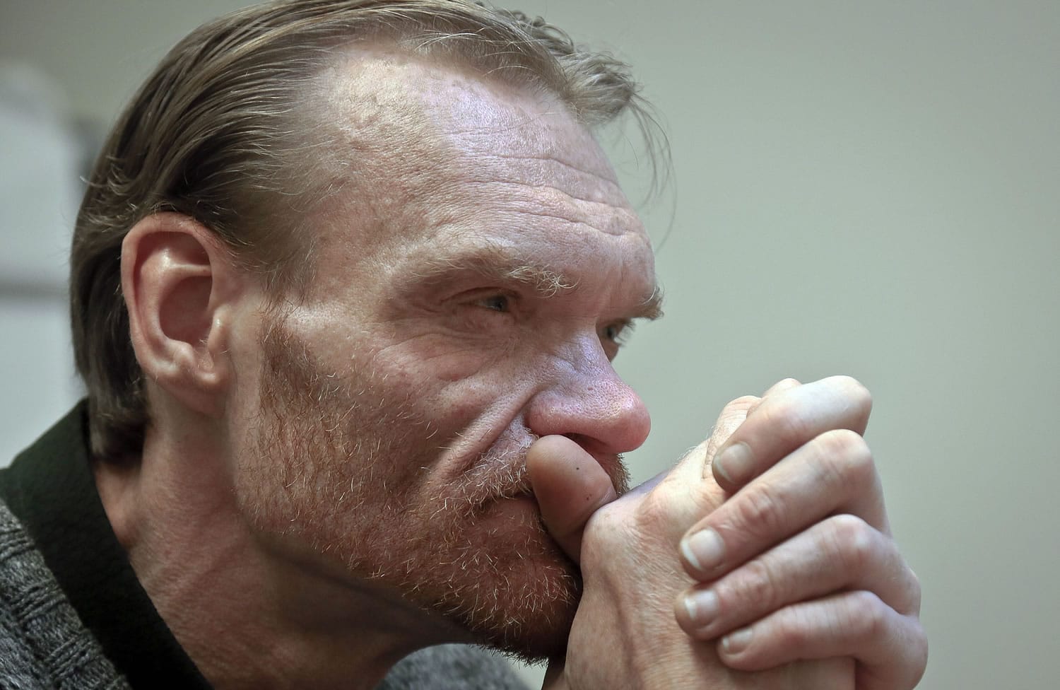 In this May 29, 2014 photo, Ken Sprague, an ex-offender who was diagnosed with HIV in 1984, listens during an interview in New York. Health professionals view imprisonment as a potentially vital chance to offer HIV testing and connect HIV-positive people to health care perhaps better than they've ever had before. Yet these experts worry about what happens post-release.