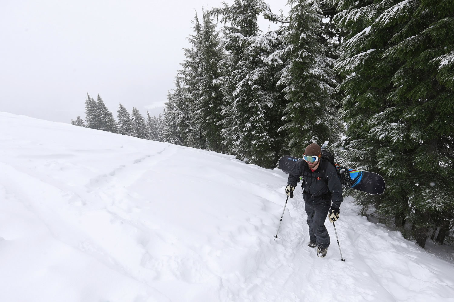 Luke Fortezzo, of Bend, Ore., hikes up the cinder cone to snowboard down at the Mount Bachelor Ski Area about 20 miles west of Bend, Ore., in November.
