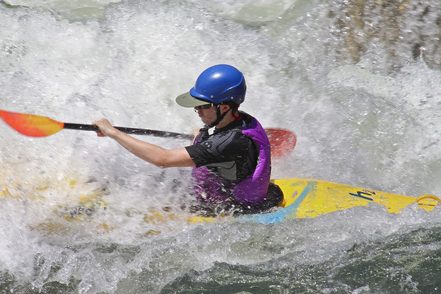Whitewater boils all around a kayaker on the Main Payette.