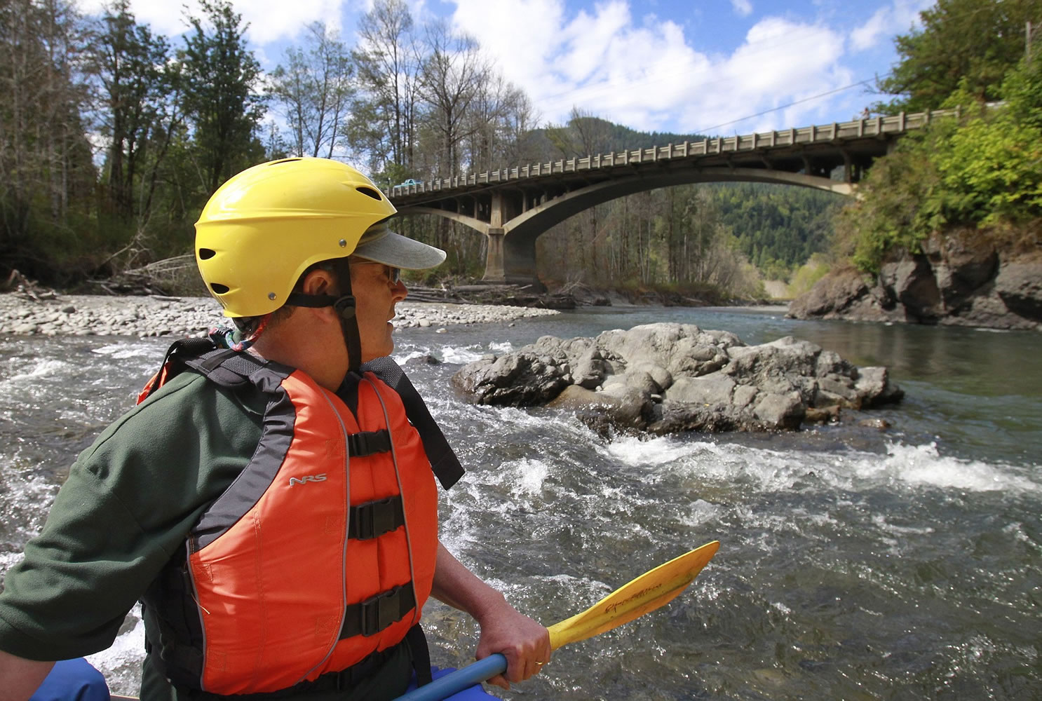 Rob Smith approaches the Highway 101 bridge Aug. 19 on the Elwha River in Olympic National Park, in an area that was underwater before the Elwha Dam was removed in 2012 near Port Angeles.