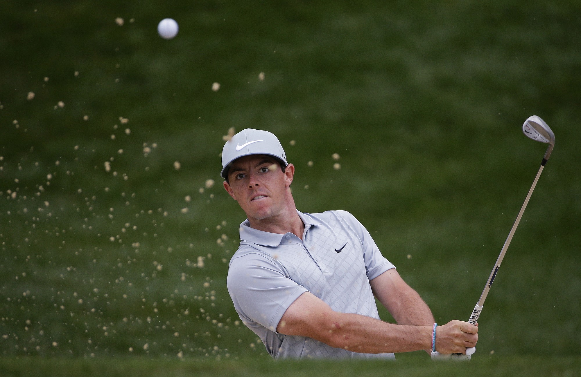 Rory McIlroy, of Northern Ireland, hits out of the bunker on the 12th hole during the second round of the PGA Championship golf tournament at Valhalla Golf Club on Friday, Aug. 8, 2014, in Louisville, Ky. (AP Photo/David J.