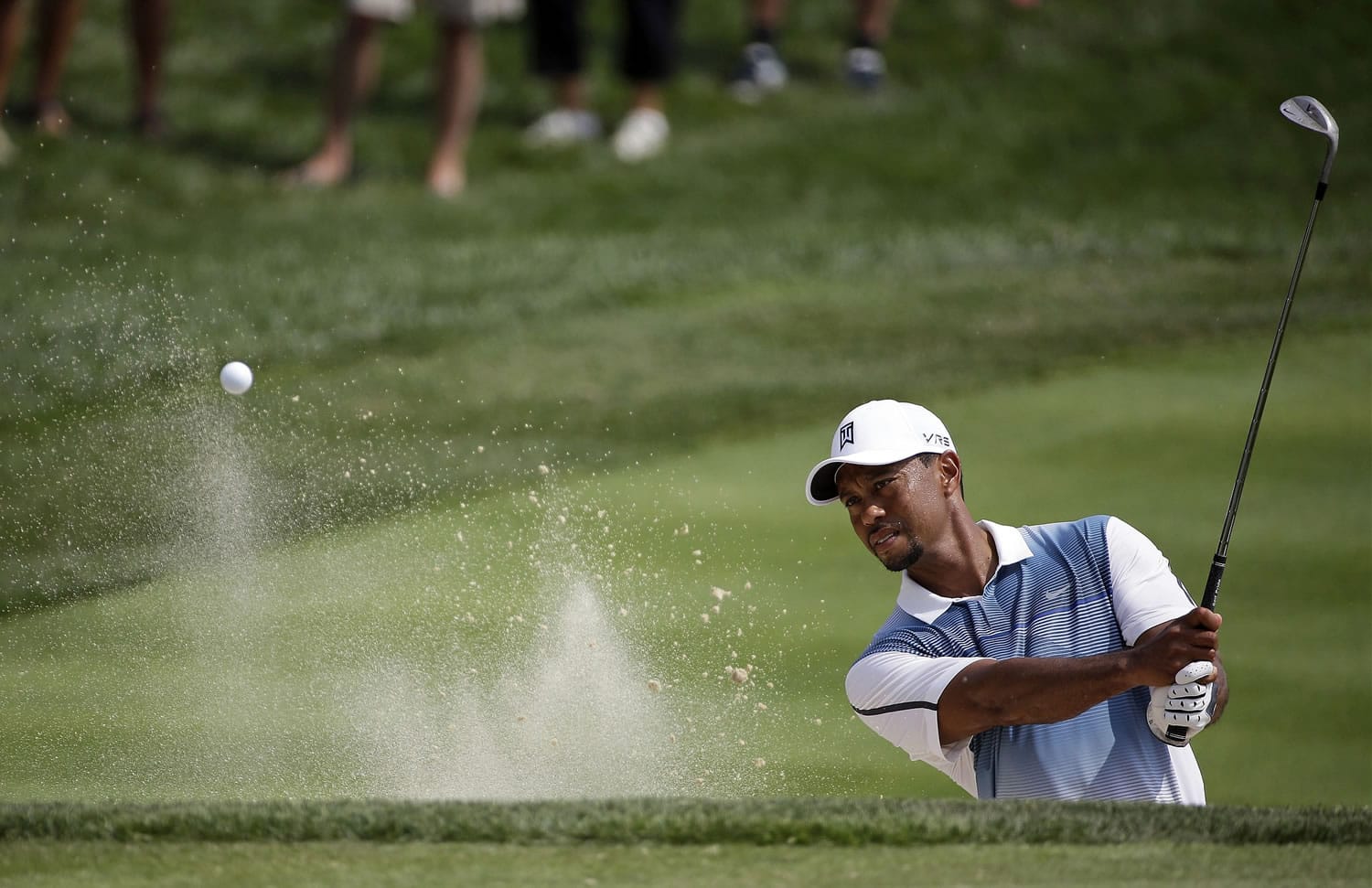 Tiger Woods hits out of the bunker on the seventh hole during a practice round for the PGA Championship golf tournament at Valhalla Golf Club on Wednesday, Aug. 6, 2014, in Louisville, Ky. The tournament is set to begin on Thursday. (AP Photo/David J.