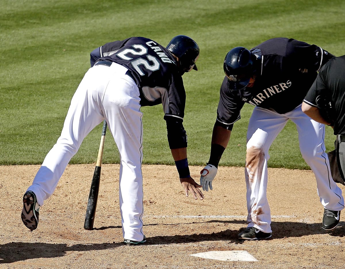 Seattle Mariners' Nelson Cruz , right, celebrates with Robinson Cano (22) after hitting a two-run home run during the third inning against the San Diego Padres on Thursday, March 5, 2015, in Peoria, Ariz.