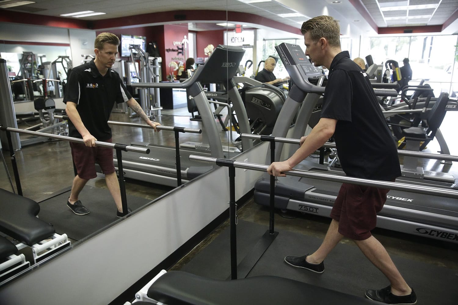 Aaron Baker, a former motocross racer who was paralyzed from the neck down in a 1999 crash, walks on a treadmill May 5 at the Center of Restorative Exercise in Los Angeles.