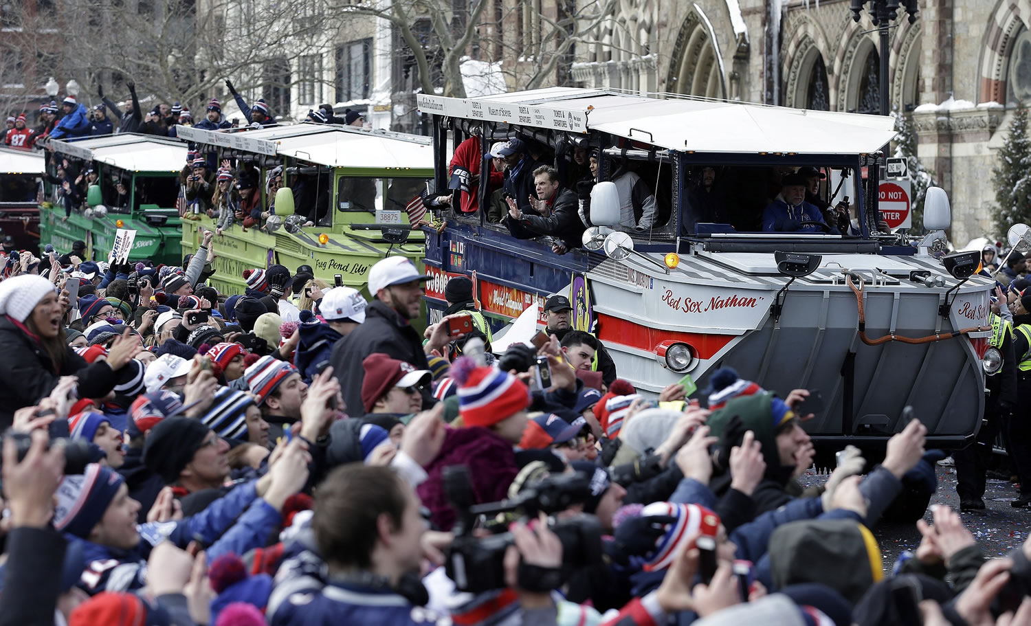 New England Patriots fans cheer as the team passes by in a procession of duck boats during a parade in Boston on Wednesday to honor the Patriots' victory over the Seattle Seahawks in Super Bowl XLIX Sunday in Glendale, Ariz.