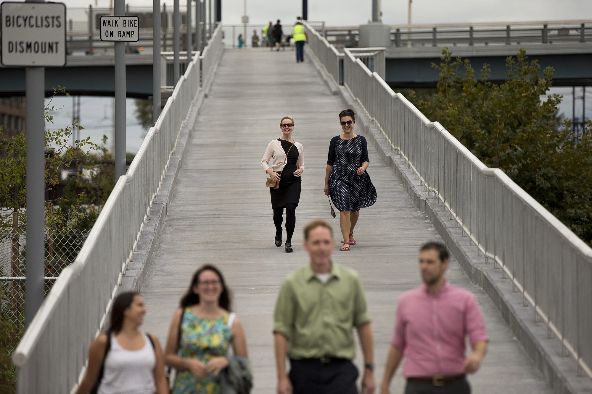 Pedestrians walk down a ramp from the South Street Bridge to the Schuylkill Banks Boardwalk on Oct. 2 in Philadelphia.
