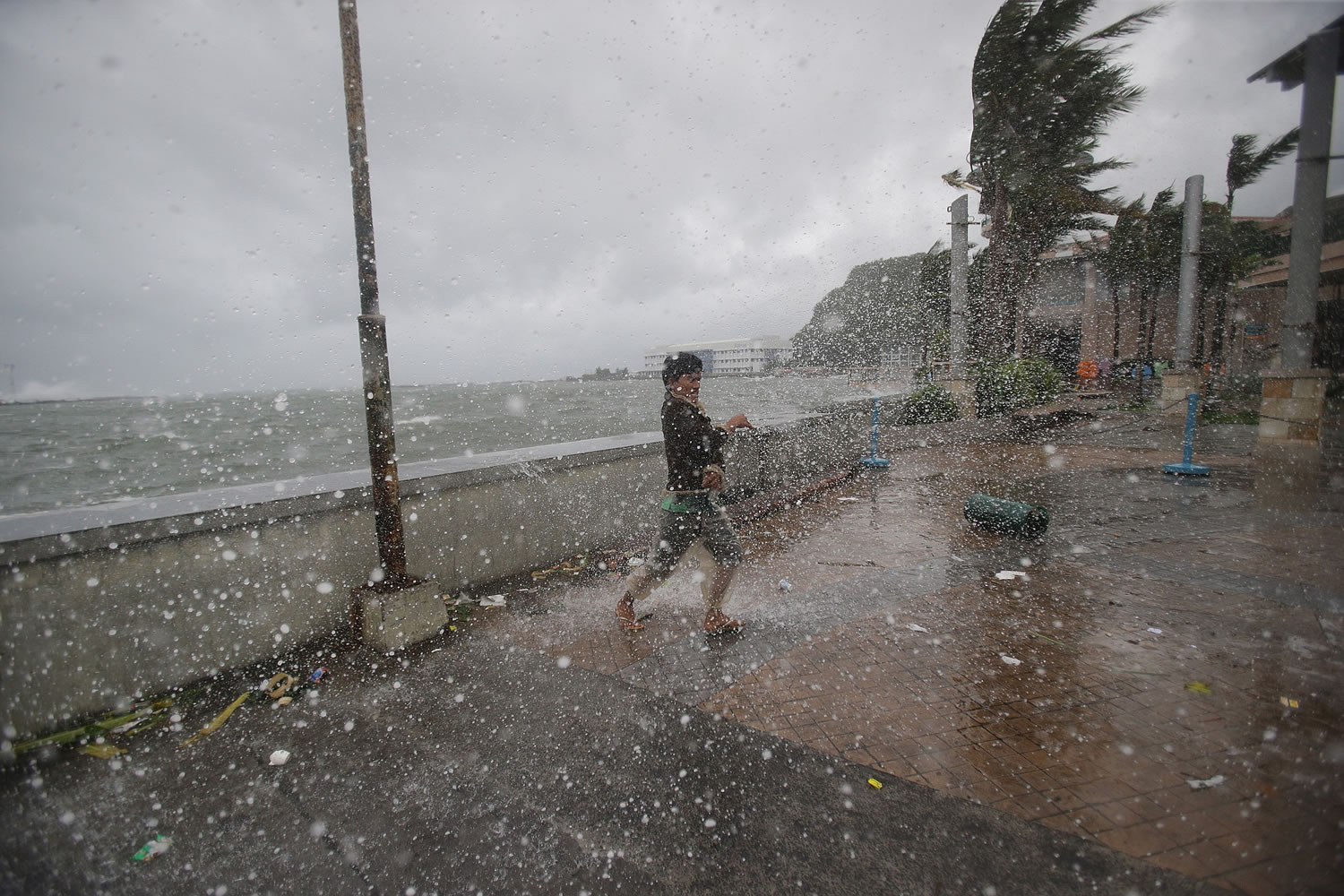 A man reacts as he strong winds and rain from Typhoon Hagupit hit shore in Legazpi, Albay province, eastern Philippines on Sunday.