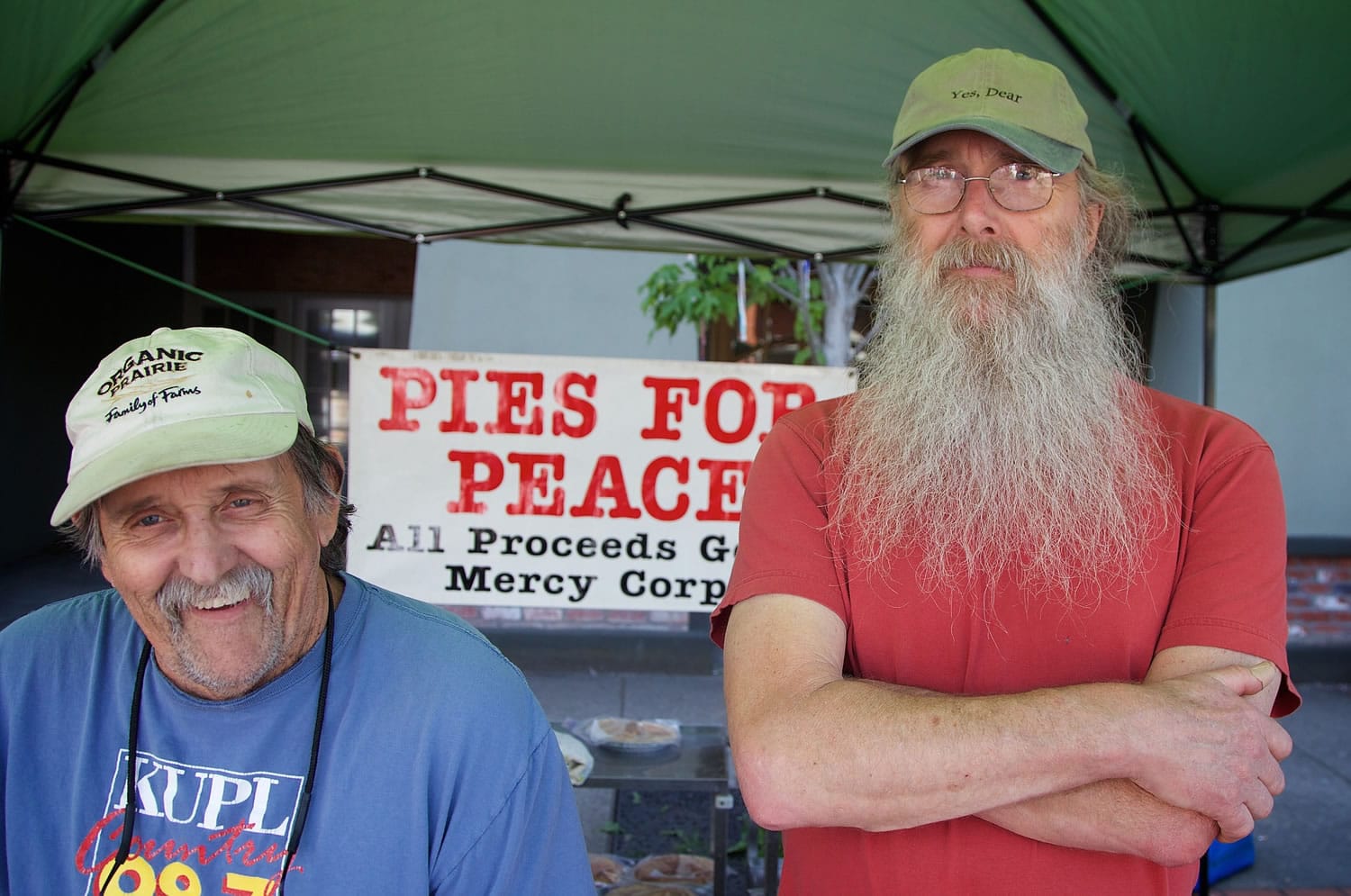 Roger Nipp, left, and Dale Case staff the &quot;Pies for Peace&quot; booth May 7 at the Forest Grove Farmers Market in Forest Grove, Ore.