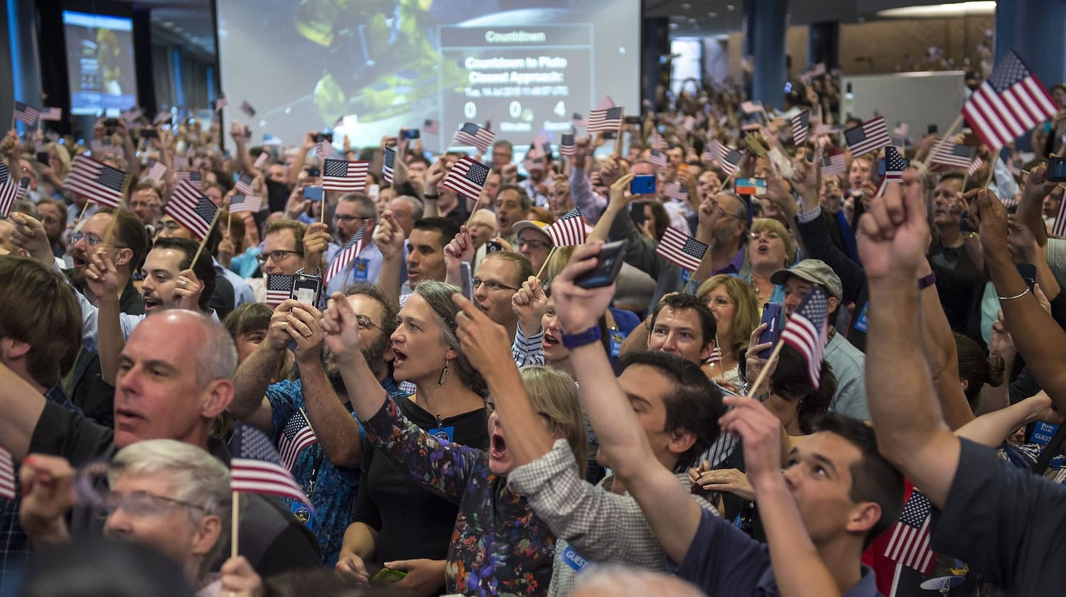 Guest and New Horizons team members count down to the spacecraft's closest approach to Pluto on Tuesday at the Johns Hopkins University Applied Physics Laboratory in Laurel, Md. The moment of closest approach for the New Horizons spacecraft came around 7:49 a.m.