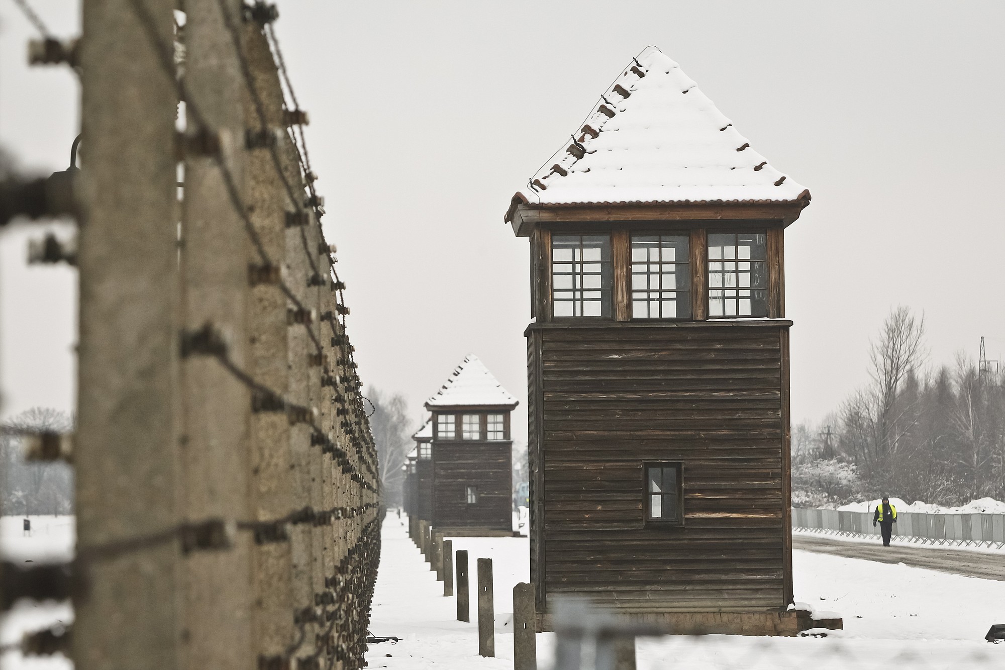 Barbed wire fences and guard towers surround the access road into the Birkenau Nazi death camp in Oswiecim, Poland, on Monday.
