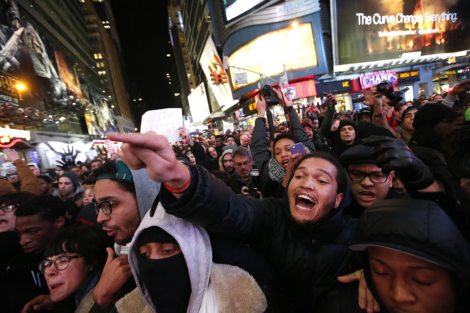 Protesters rallying against a grand jury's decision not to indict the police officer involved in the death of Eric Garner confront police as they attempt to block traffic Thursday near Times Square in New York.