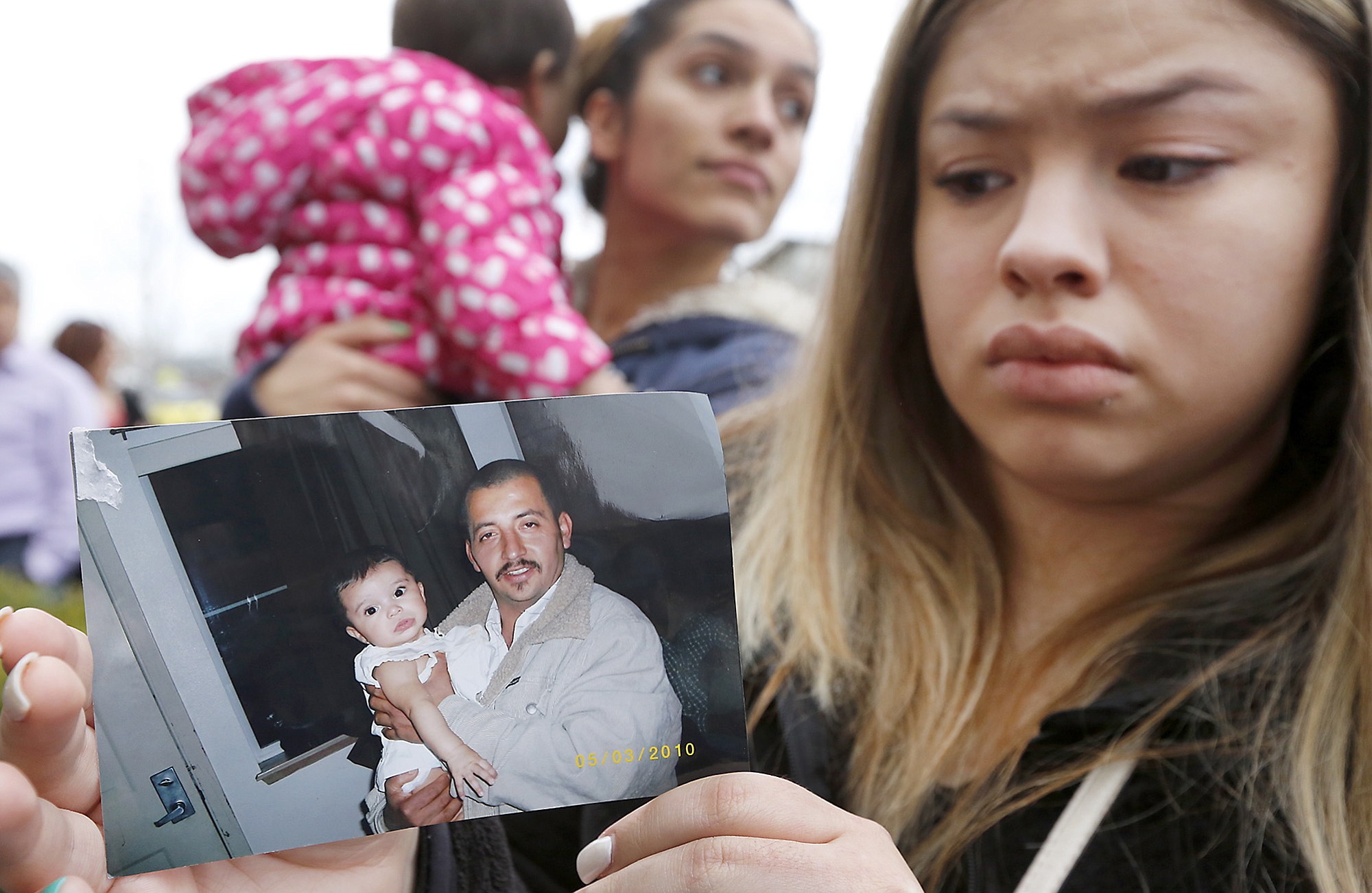 Erika Zambrano holds a 2010 photo of shooting victim Antonio Zambrano-Montes, Wednesday, Feb. 11, 2015, while standing outside the city hall building in Pasco, Wash. A rally was held in support of Zambrano-Montes, who was shot and killed by Pasco police officers during a confrontation at the busy intersection.