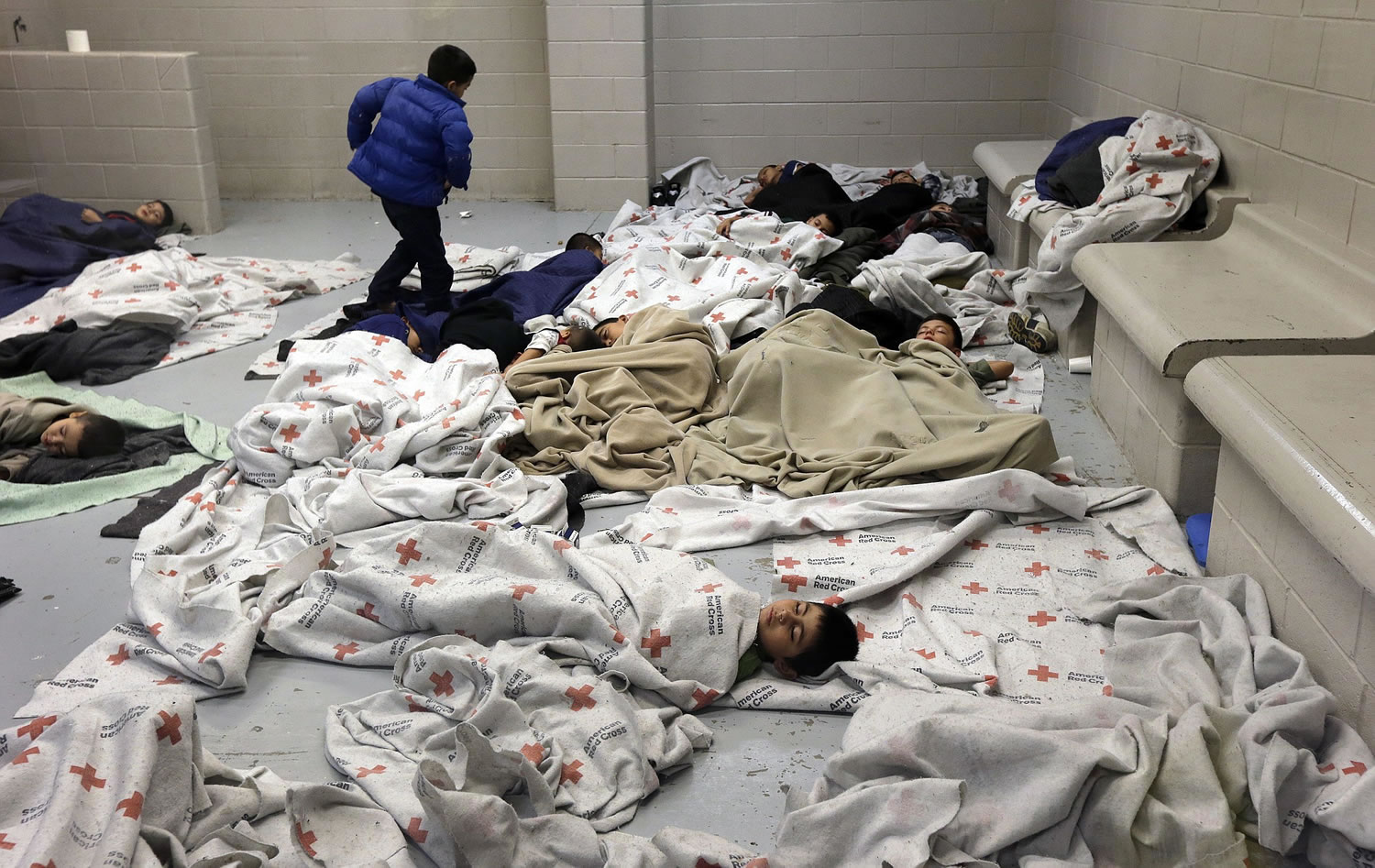 Detainees sleep in a holding cell at a U.S.