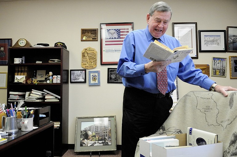 Former Vancouver Mayor Royce Pollard, shown here enjoying a book of quotes from President Harry S. Truman while cleaning out his office at City Hall last December.