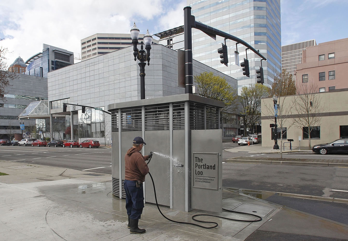 Rodney Haven, of Clean and Safe, washes down the exterior of a Portland Loo on April 12, 2012, in Portland.