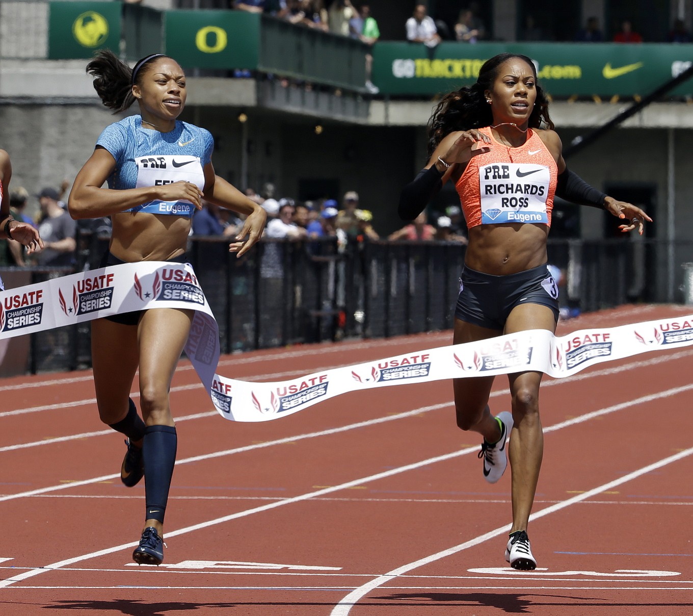 Allyson Felix, left, hits the tape ahead of Sanya Richards-Ross to win the 400-meter race during the Prefontaine Classic track and field meet in Eugene, Ore., Saturday, May 30, 2015.