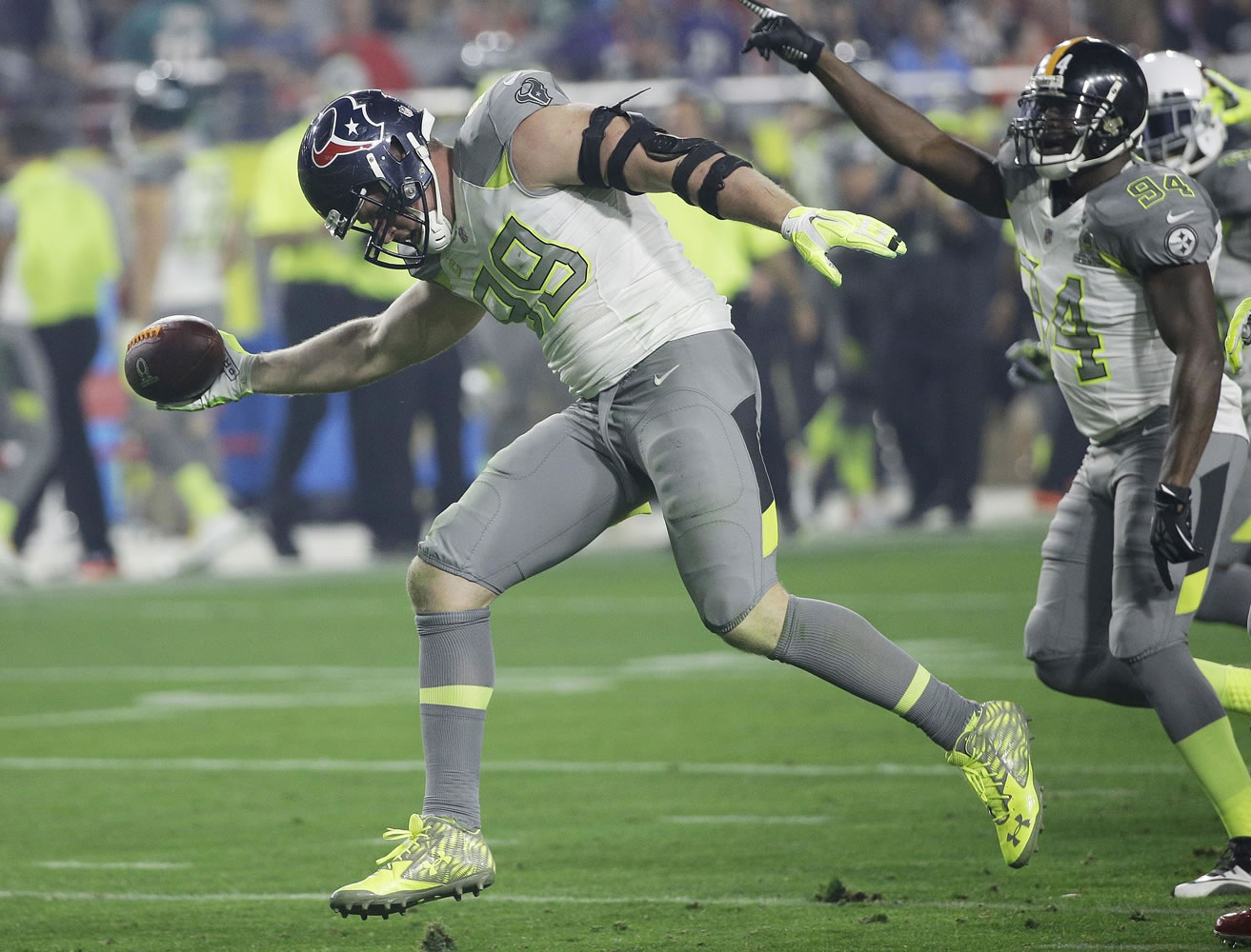 Houston Texans' J.J. Watt (99) celebrates after recovering a fumble during the second half of the NFL Pro Bowl on Sunday, Jan. 25, 2015, in Glendale, Ariz. (AP Photo/David J.
