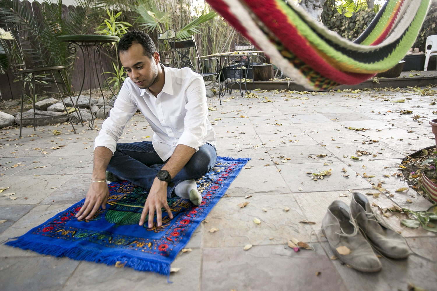 Omar Akersim, 26, a leader among gay Muslims, sits on his prayer rug Friday at his home in Los Angeles.
