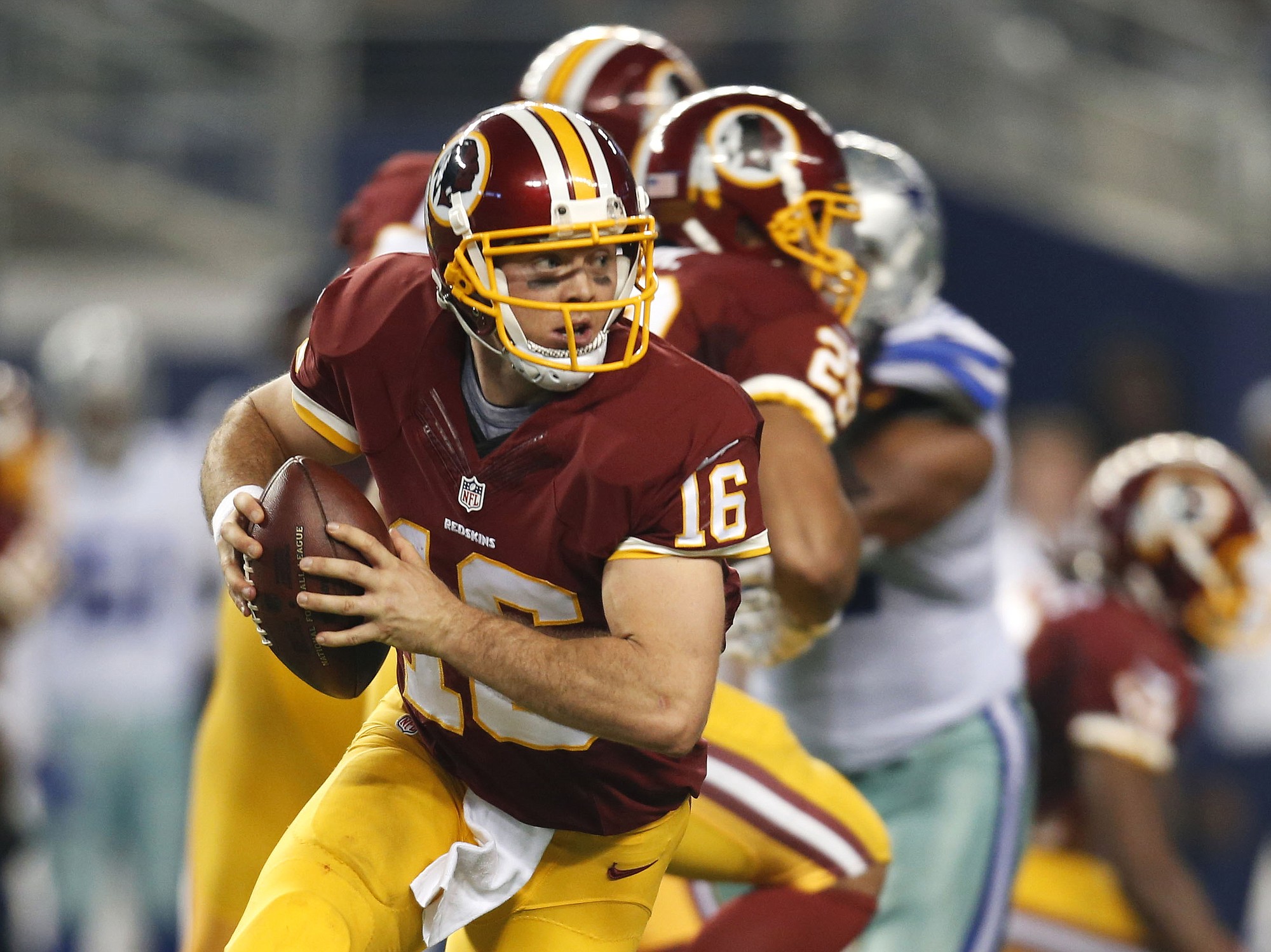 Washington Redskins' Colt McCoy (16) scrambles out of the pocket during the second half against the Dallas Cowboys, Monday, Oct. 27, 2014, in Arlington, Texas.