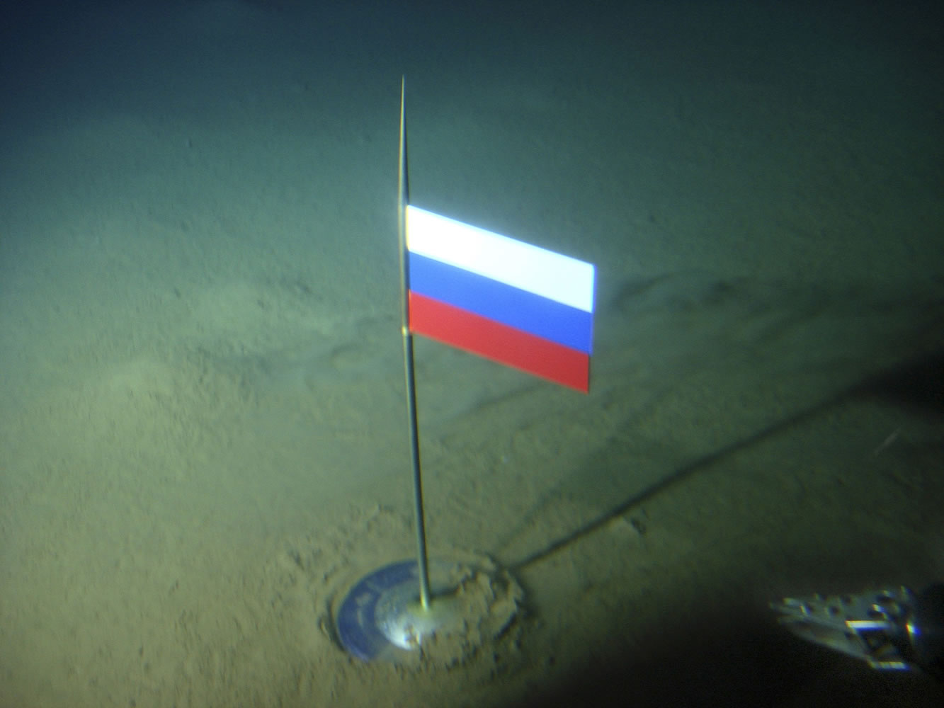 Association of Russian Polar Explorers
The Russian flag is seen seconds after it was planted in August 2007 by the Mir-1 mini submarine on the Arctic Ocean seabed under the North Pole. The Russian Foreign Ministry said Tuesday that Russia is claiming more than 463,000 square miles of Arctic sea shelf.