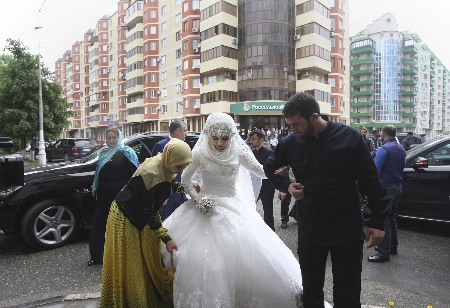 A bride, Chechen Kheda Goilabiyeva, is taken by head of the Chechen leader's administration, Magomed Daudov, to a wedding registry office for her wedding with Chechen police officer Nazhud Guchigov, in Chechnya's provincial capital Grozny, Russia, on Saturday.