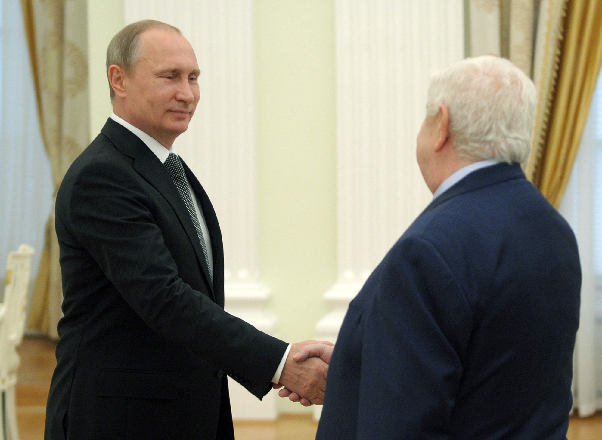 Syrian Foreign Minister Walid al-Mualem, right, meets with Russian President Vladimir Putin in Moscow's Kremlin, Russia on Monday, June 29, 2015.