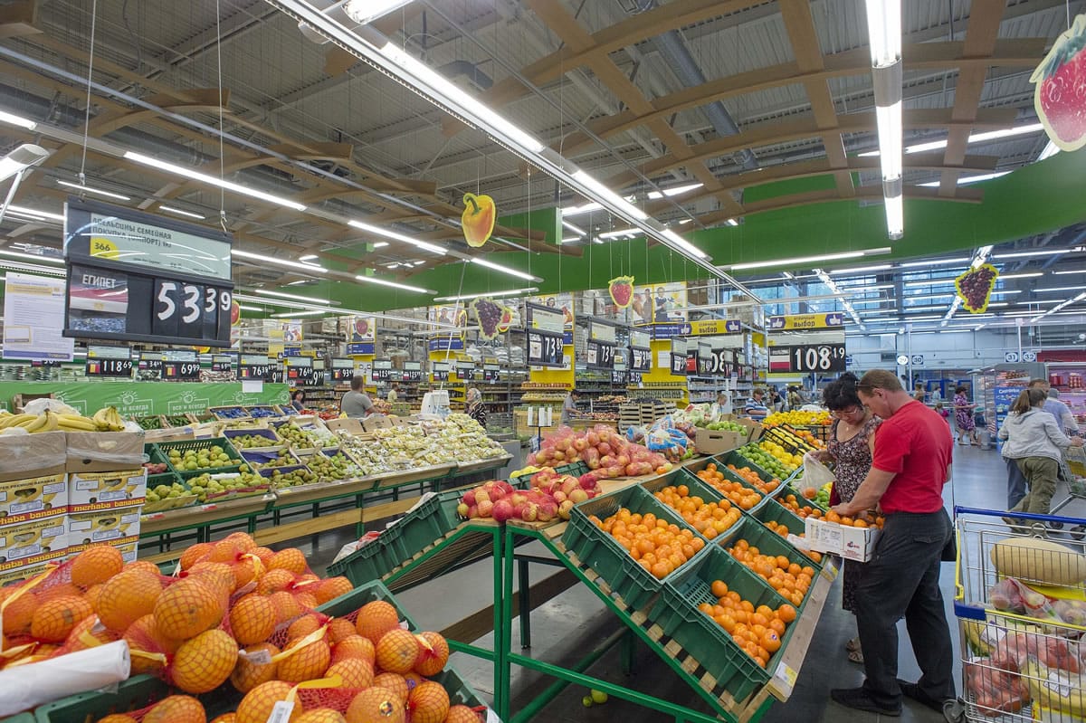 Customers look at shelves with imported fruit and vegetables at a supermarket in Novosibirsk, about 2,800 kilometers (1,750 miles) east of Moscow, Russia, Thursday, Aug. 7, 2014. Russia banned most food imports from the West on Thursday in retaliation for sanctions over Ukraine, an unexpectedly sweeping move that will cost farmers in North America, Europe and Australia billions of dollars but will also likely lead to empty shelves in Russian cities.