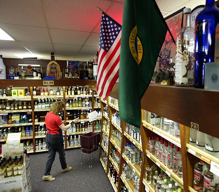 The Washington state flag hangs over shelves at the State Liquor Store in Tumwater.