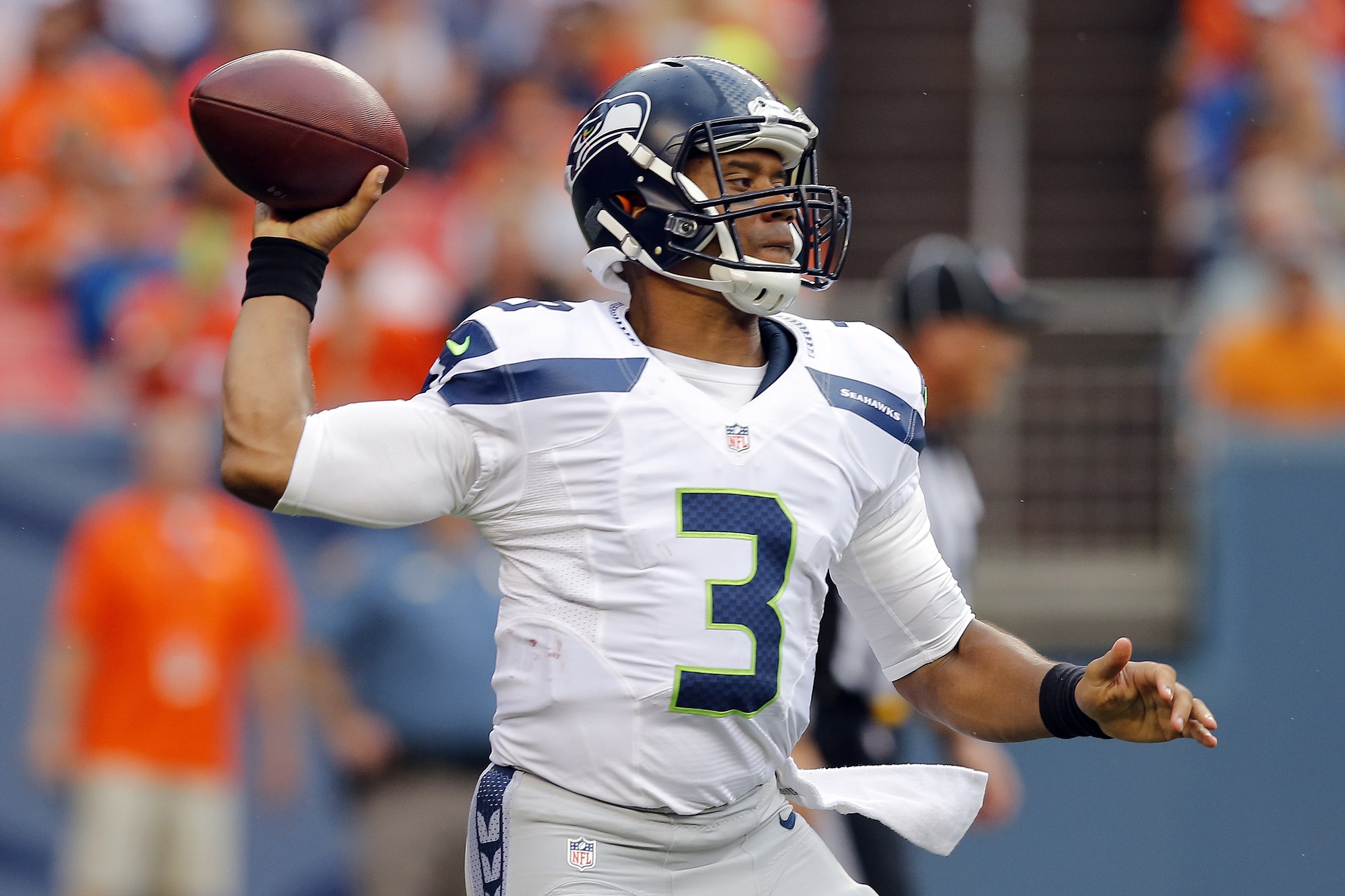 Seattle Seahawks quarterback Russell Wilson (3) throws against the Denver Broncos during the first half of an NFL preseason football game, Thursday, Aug. 7, 2014, in Denver.
