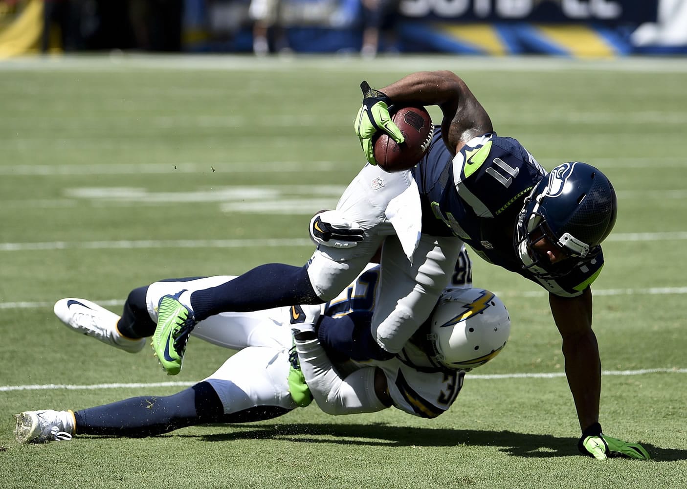 Seattle Seahawks wide receiver Percy Harvin, right, is tackled by San Diego Chargers strong safety Marcus Gilchrist during the first half Sunday, Sept. 14, 2014, in San Diego.