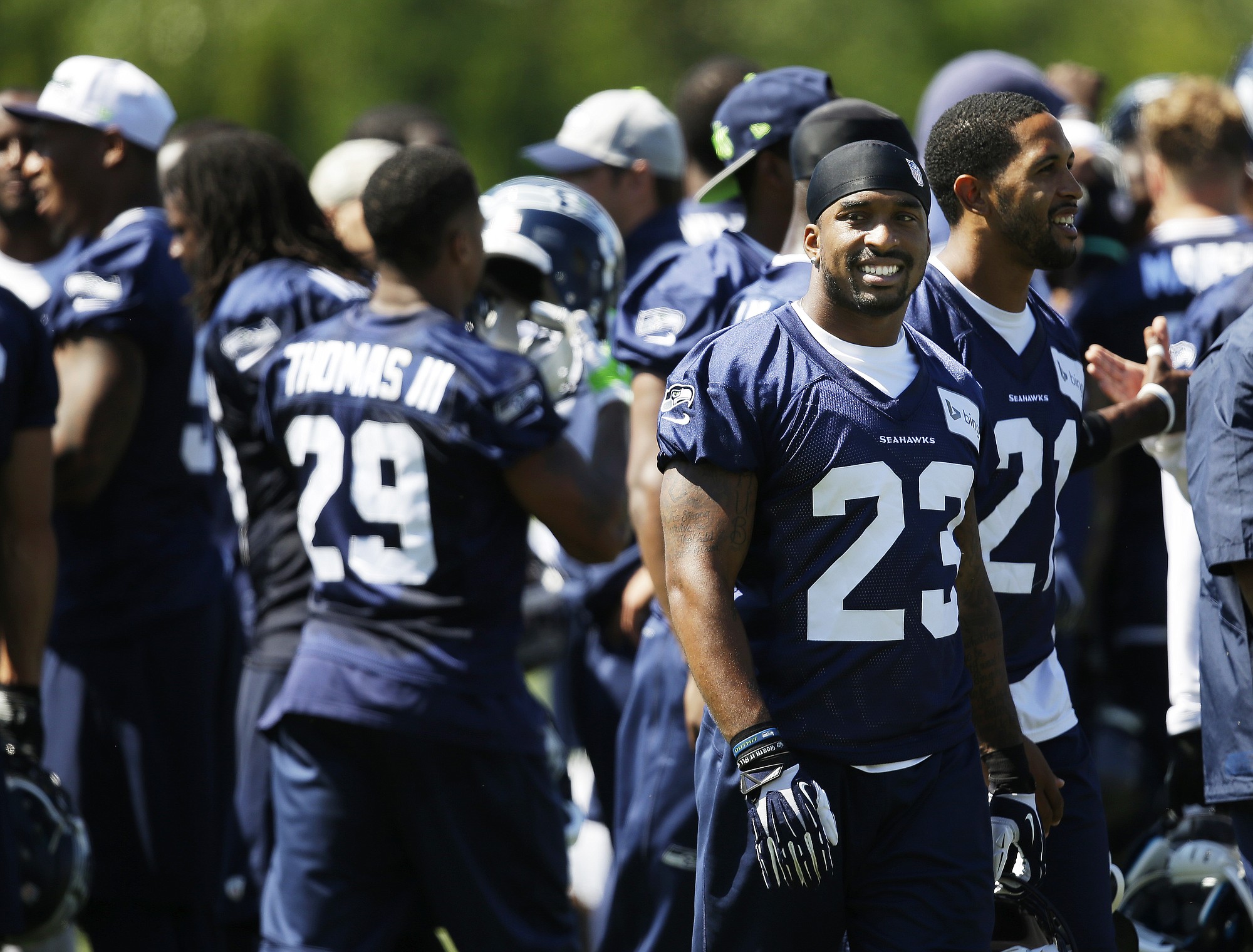 Seattle Seahawks strong safety Jeron Johnson (23) stands with teammates as the huddle breaks up following a session of NFL football training camp, Tuesday, Aug. 5, 2014, in Renton, Wash. (AP Photo/Ted S.