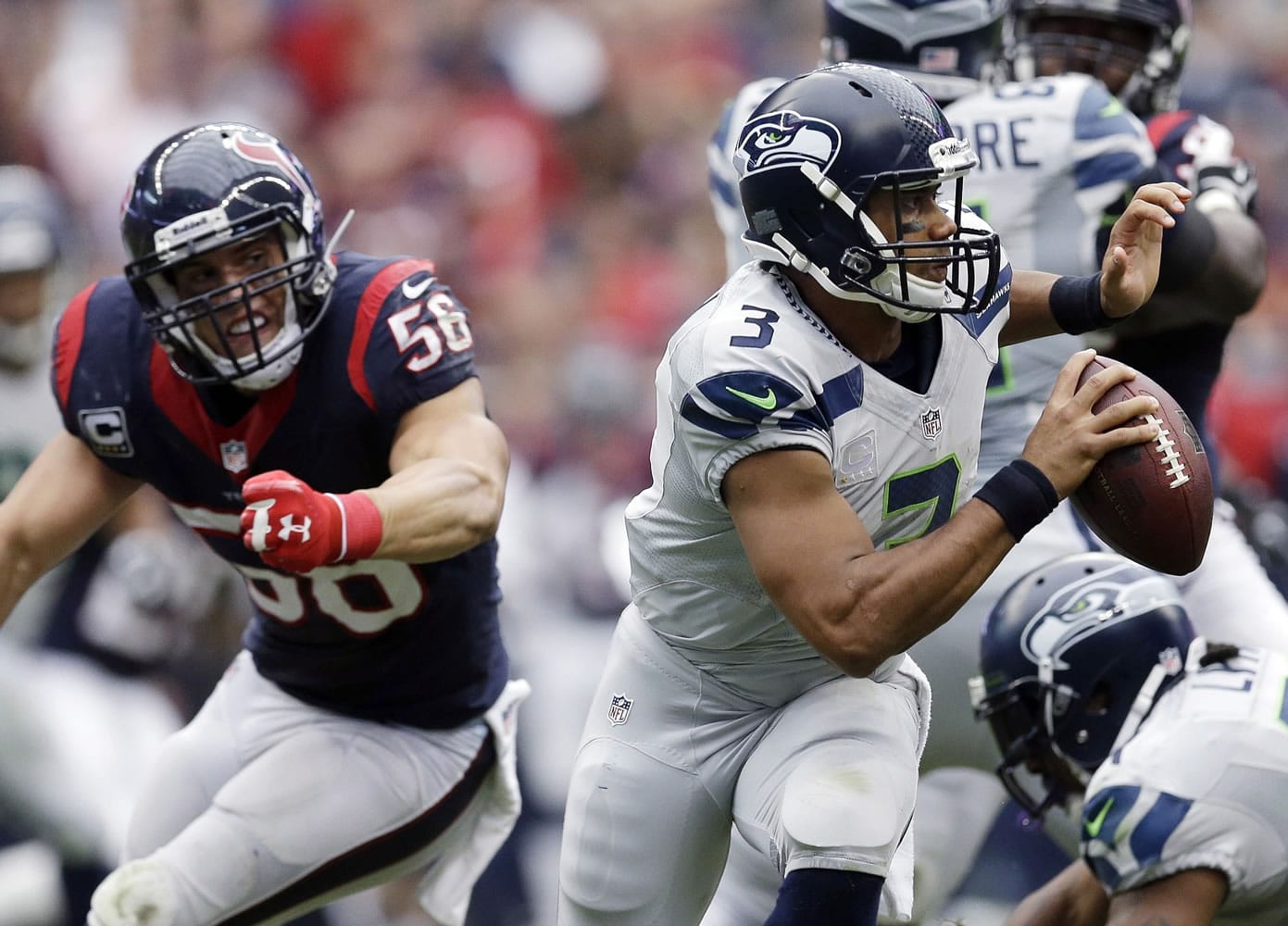 Seattle Seahawks' Russell Wilson (3) is pressured by Houston Texans' Brian Cushing (56) during the third quarter an NFL football game on Sunday, Sept. 29, 2013, in Houston. (AP Photo/David J.